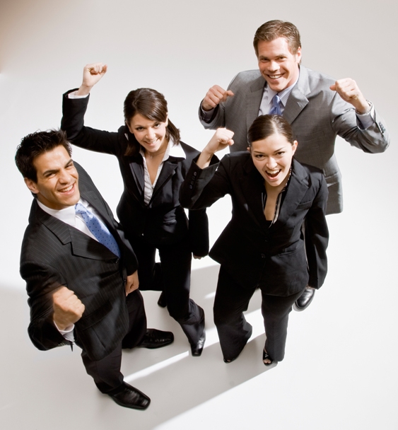 Excited co-workers cheering and celebrating their success